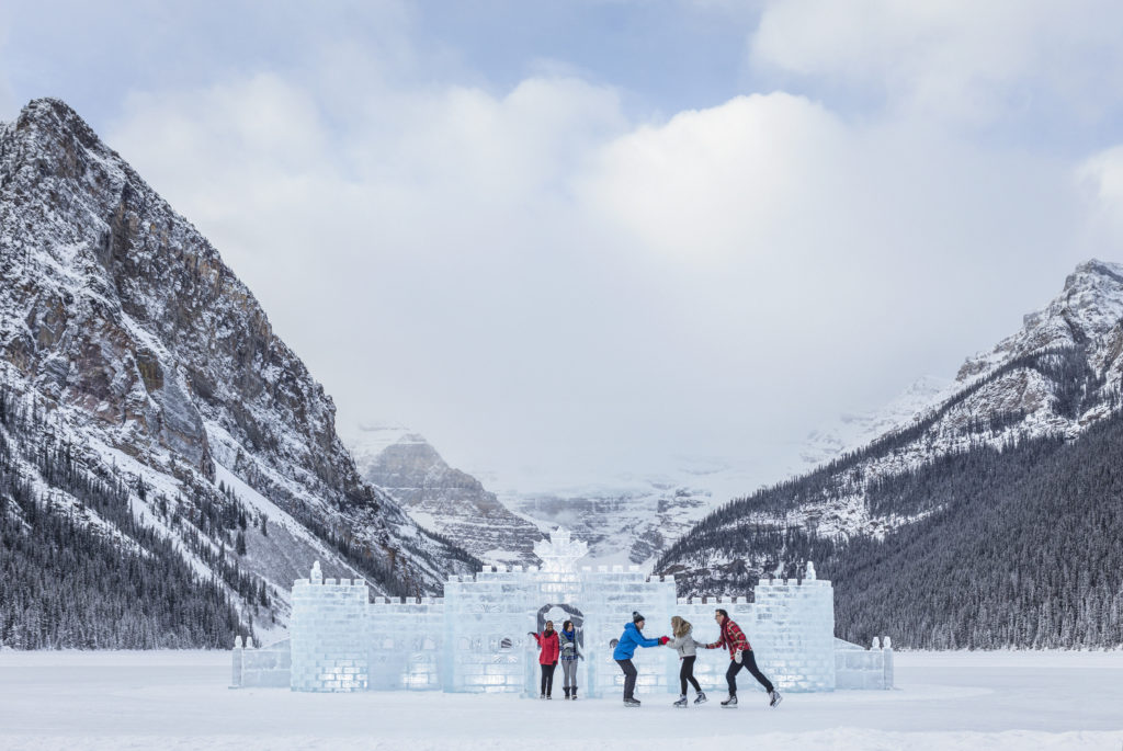 Friends skating around the Lake Louise Ice Castle