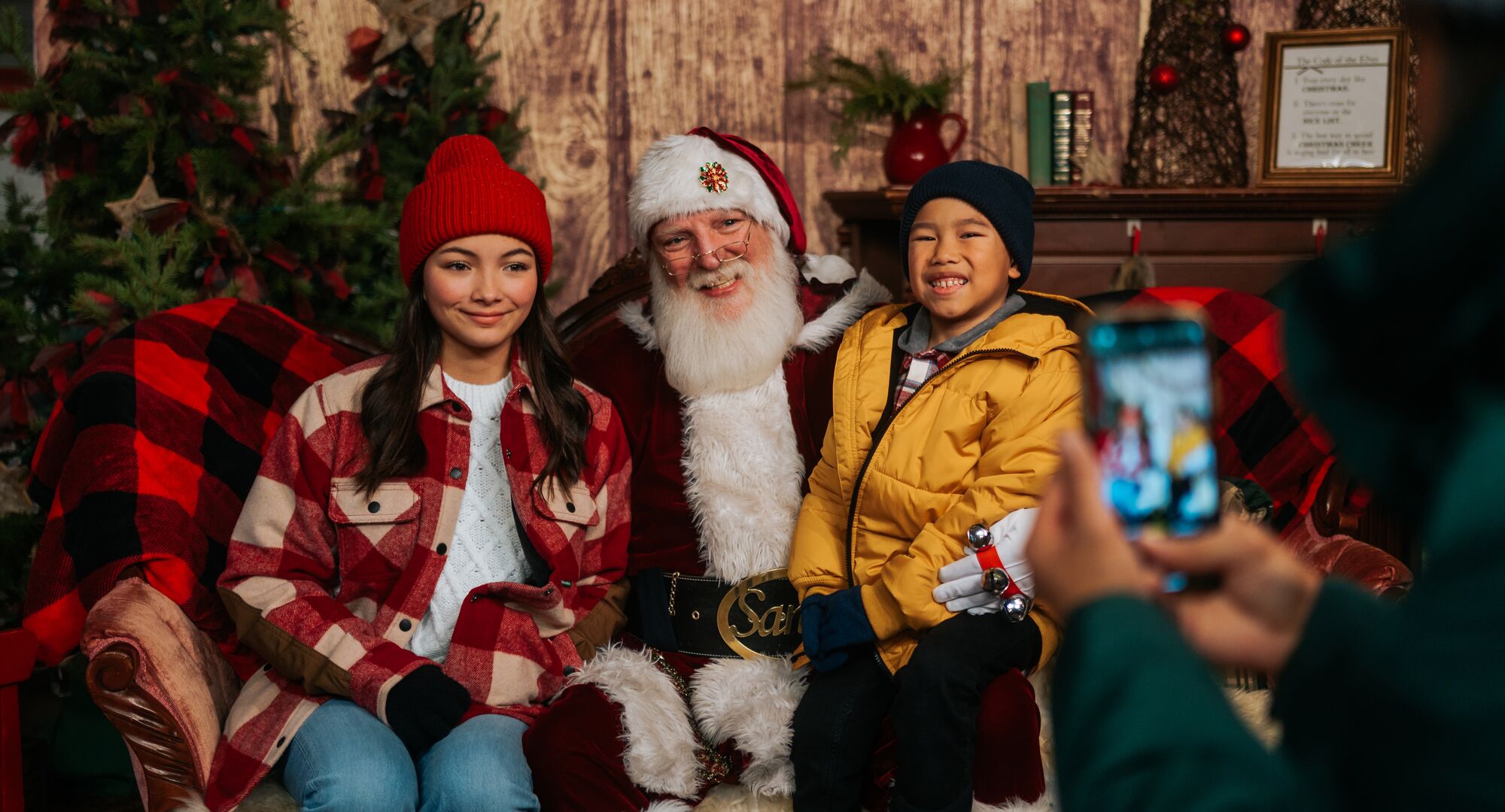 Siblings pose with Santa at the Banff Christmas Market.