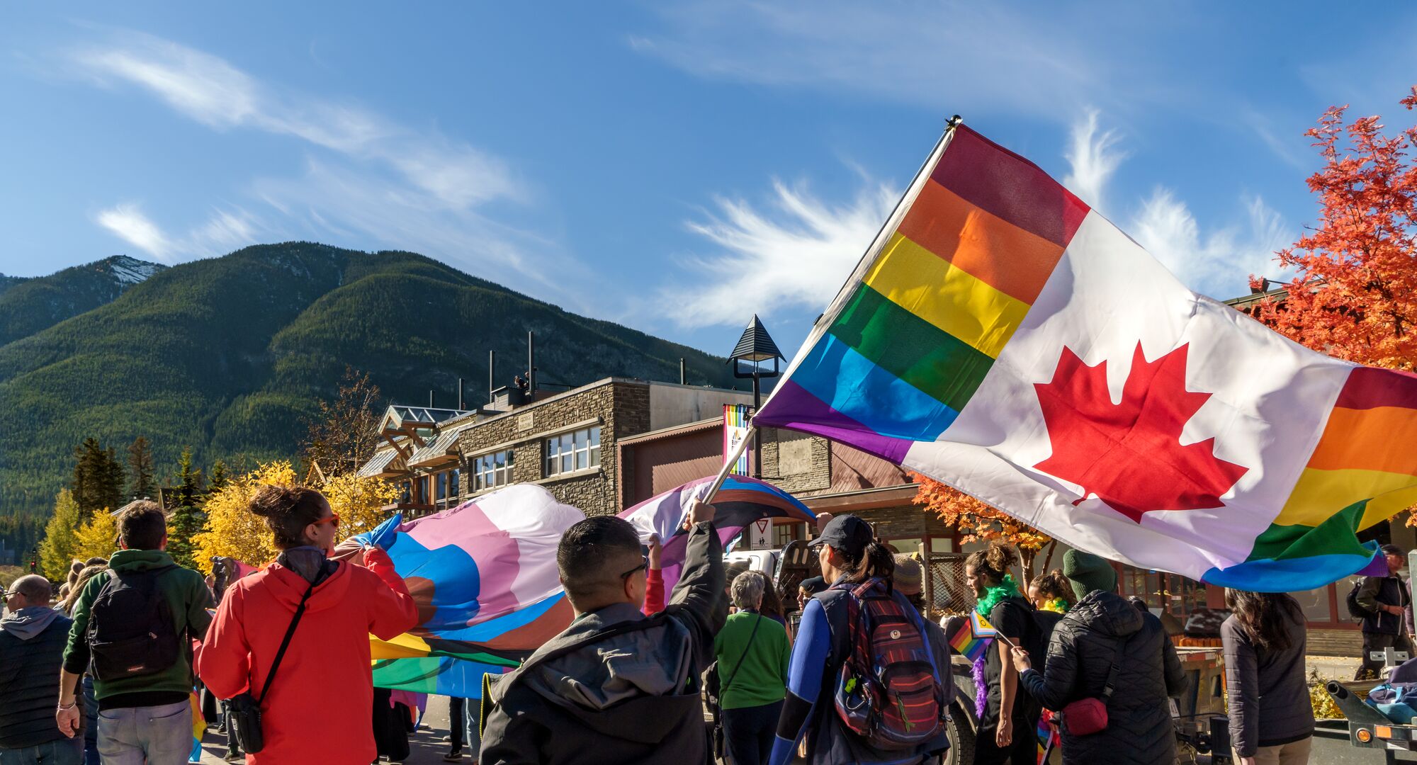 Canadian Pride Flag flying above the crowds in Banff National Park.
