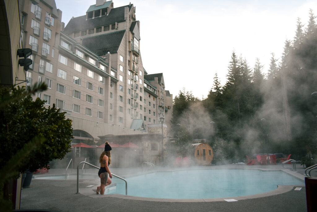 women entering the pool in the winter at fairmont chateau whistler