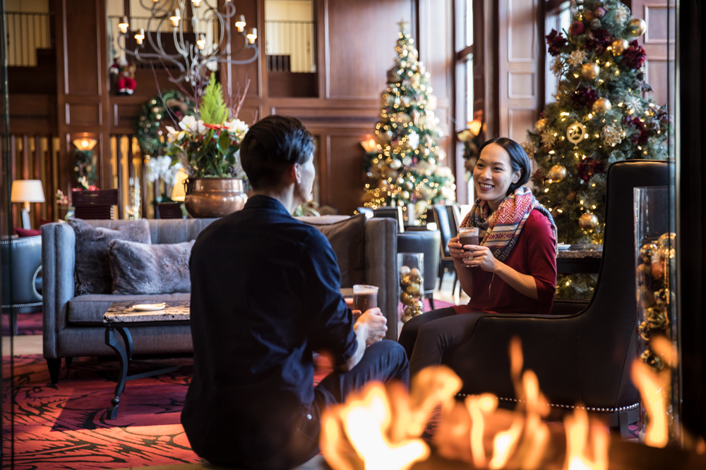 Couple sipping hot chocolate at Rimrock Resort Hotel in Banff