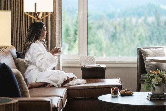 Women having a moment with her coffee in the Gold Room at Fairmont Whistler