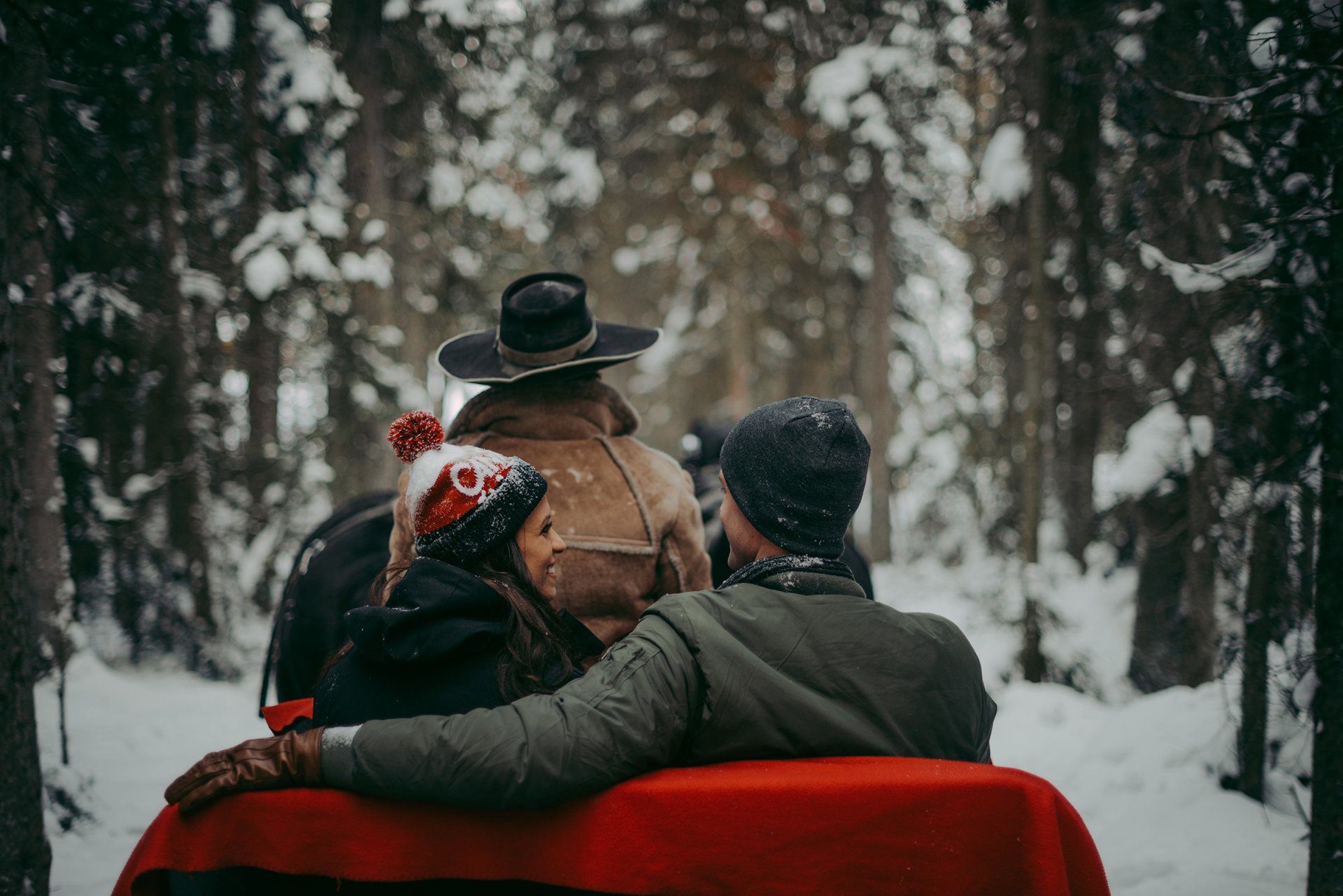 Couple in a snowy sleigh ride in Lake Louise