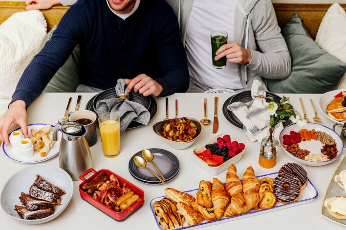 Couple enjoying a feast of breakfast at the Fairmont Chateau Whistler on the Gold Floor