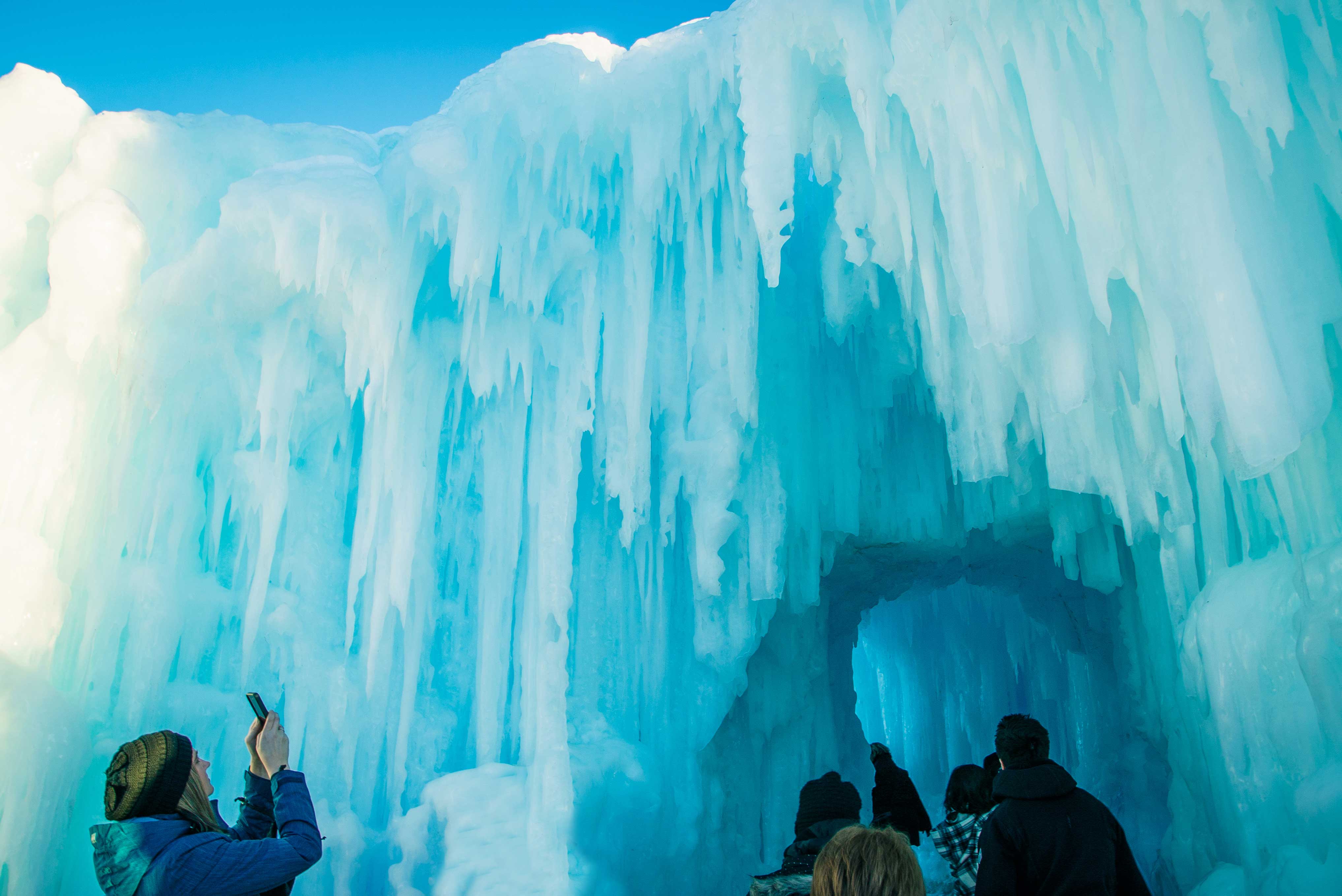 People enjoying all the things to do in winter in Edmonton, including the Ice Castles
