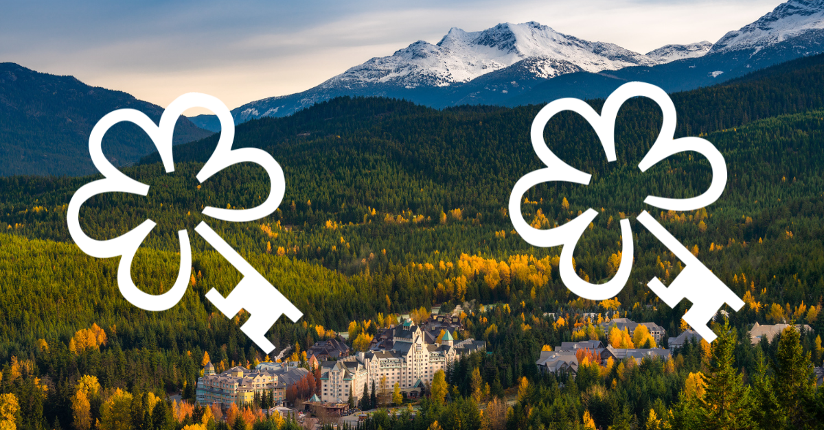 View of the Fairmont Chateau Whistler in the fall with 2 Michelin Keys overlayed on it