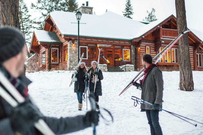 Friends in front of Signature Cabins in Jasper about to go cross-country skiing.