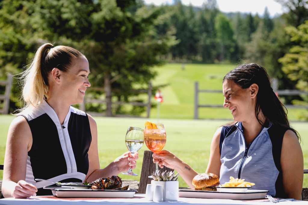 Two women having lunch and a cocktail at Chateau Whistler Golf Course